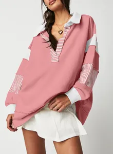Detailed view of pink oversized deep V-neck sweatshirt with striped patchwork sleeves