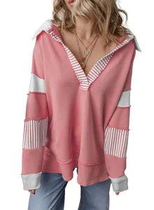 Detail view of pink oversized sweatshirt with deep V-neck and white stripes