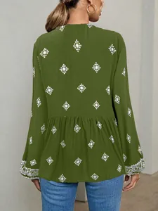 Back view of a green ethnic print long sleeve blouse with lantern sleeves