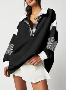 Close-up of oversized deep V-neck polo sweatshirt with striped patchwork detail textures