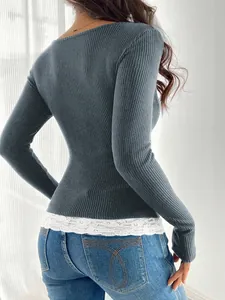 Detail view of slim fit ribbed long sleeve top with elegant white lace trim hem