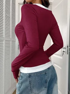 Detail view of a burgundy and white faux two-piece long sleeve top showing the back fit.