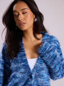 Close-up detail of a shaggy blue deep V-neck cardigan showing soft plush fabric texture