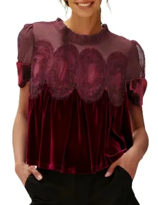 Close-up of elegant burgundy velvet top with mesh embroidery and lace detailing