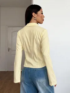 Back view of a fashionable yellow and white vertical striped long-sleeve casual shirt for women