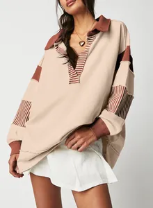 Detail of oversized V-neck sweatshirt with striped patchwork and color-block design