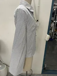 Side view detail of a classic striped long-sleeve shirt displayed on a tailor mannequin