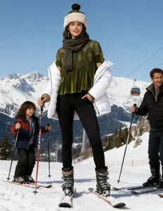 Detail of dark green velvet top with intricate mesh embroidery and lace trim on snowy mountains.