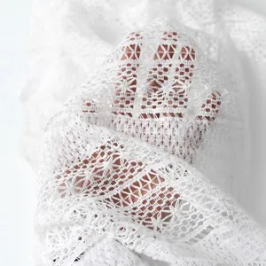 Élégante chemise en dentelle blanche ajourée avec broderie florale et texture respirante