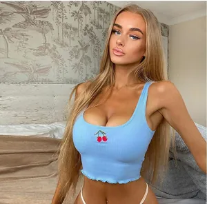 Detailed view of light blue ribbed crop top vest featuring delicate cherry embroidery