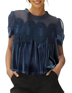 Detail of elegant blue velvet blouse featuring delicate lace trim and mesh panel.