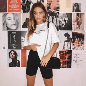 Model wearing solid black high-waisted yoga biker shorts for a trendy street style look