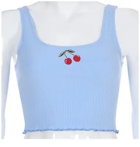 Close-up view of a light blue ribbed crop top featuring cherry embroidery on the chest.