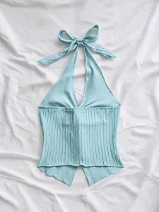 Detail view of the light blue ribbed halter top featuring a stylish tie-neck bow design