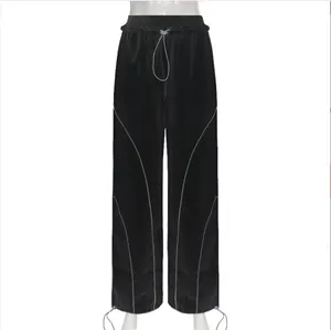 Front view of black high-waisted joggers featuring reflective piping and adjustable drawstrings