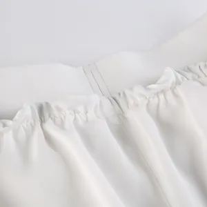 Detailed close-up showing the white elastic waistband with delicate gathering on trousers