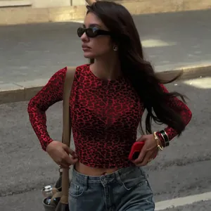 Close-up of red leopard print mesh top showing tight fit and sheer texture in street view