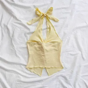 Close-up of the textured ribbed fabric and backless tie-up design of the halter top.