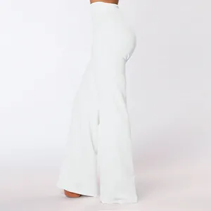 Side view of white high-waisted flared trousers with slim fit bell bottom design
