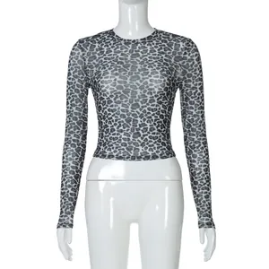 Detail view of a leopard print sheer mesh long sleeve crew neck crop top for women.