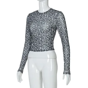 Close-up detail of women's leopard print mesh long sleeve top on white mannequin stand