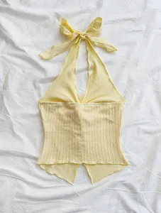 Yellow knitted halter neck backless crop top featuring a minimalist ribbed texture design