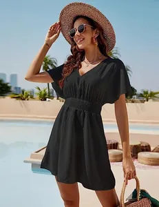 Elegant black V-neck summer beach dress featuring smocked waist and flutter sleeve detail
