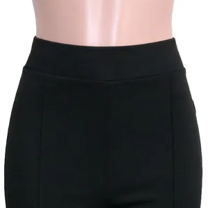 Detail view of high-waisted black slim-fit trousers with decorative vertical seams