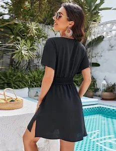 Back view of a black V-neck beach dress with pleated waist and side slit