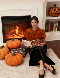 Elegant orange mesh embroidery velvet top styled in a cozy fall fireplace scene