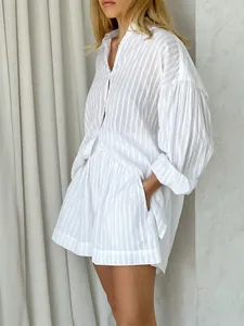 Detailed view of white striped shirt and shorts set featuring puff sleeve design