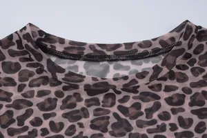 Detailed close-up of the round neckline on a leopard print mesh slim-fit top
