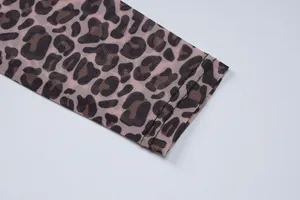 Macro detail of leopard print mesh sleeve showing fabric texture and neat stitching