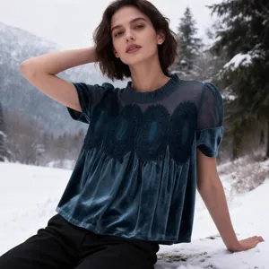 Elegant teal velvet blouse with mesh embroidery and short sleeves in snowy landscape