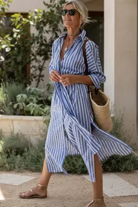 Chic blue and white striped shirt dress featuring side slits, perfect for summer resort wear