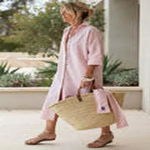 Women's casual pink striped shirt dress with midi sleeves in an outdoor lifestyle setting