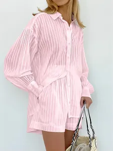 Detailed view of women's pink striped shirt set with pleated sleeves and casual shorts