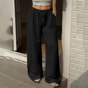 Detailed view of fashionable high-waist black wide-leg trousers with drawstring waist.
