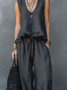 Close-up of summer linen sleeveless top with ruffle hem and matching wide-leg trousers