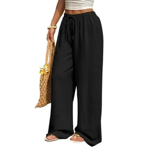 Detailed shot of stylish women's high-waisted black wide-leg trousers with drawstring waist