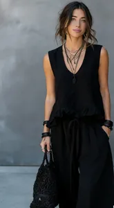 Fashionable black sleeveless ruffled top and loose wide-leg pants summer two-piece outfit.
