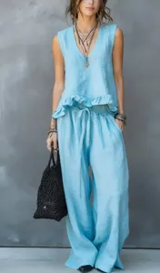 Detail view of light blue sleeveless ruffle top and wide-leg linen pants for summer wear