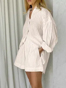 Detailed view of white striped jacquard shirt and shorts set with elegant puff sleeves