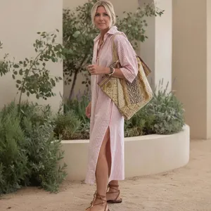 Pink and white striped shirt dress with long sleeves and high side slits