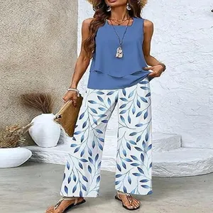 Close-up detail of women's sleeveless tank top and blue leaf print wide-leg pants set