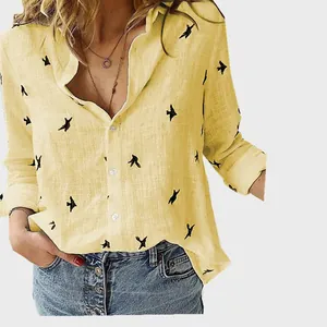 Detailed shot of yellow linen shirt for women featuring delicate black bird prints.