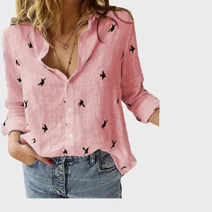 Detailed view of pink linen shirt featuring black bird prints and casual buttons