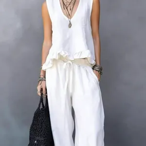 Summer white linen two-piece set with sleeveless ruffle top and loose wide-leg pants.