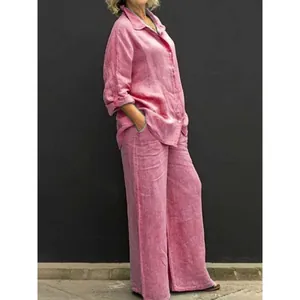 Casual pink two-piece linen-style set with button-down shirt and wide-leg trousers