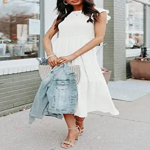 Elegant white flutter sleeve pleated tiered midi dress shown in a lifestyle street setting